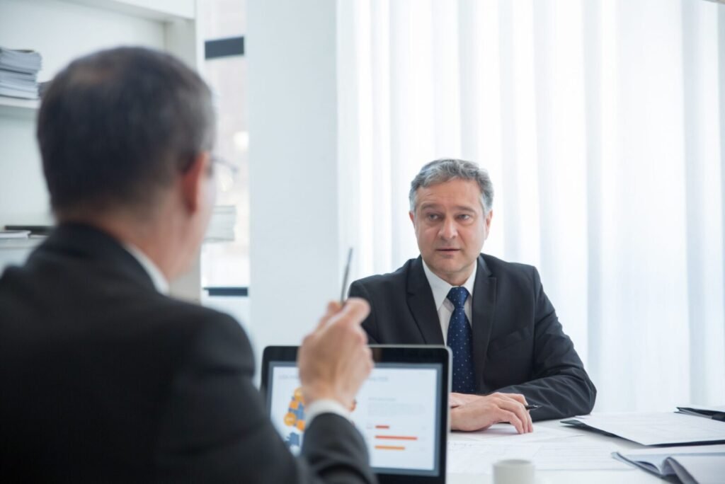 Business professionals in a focused discussion during an office meeting.